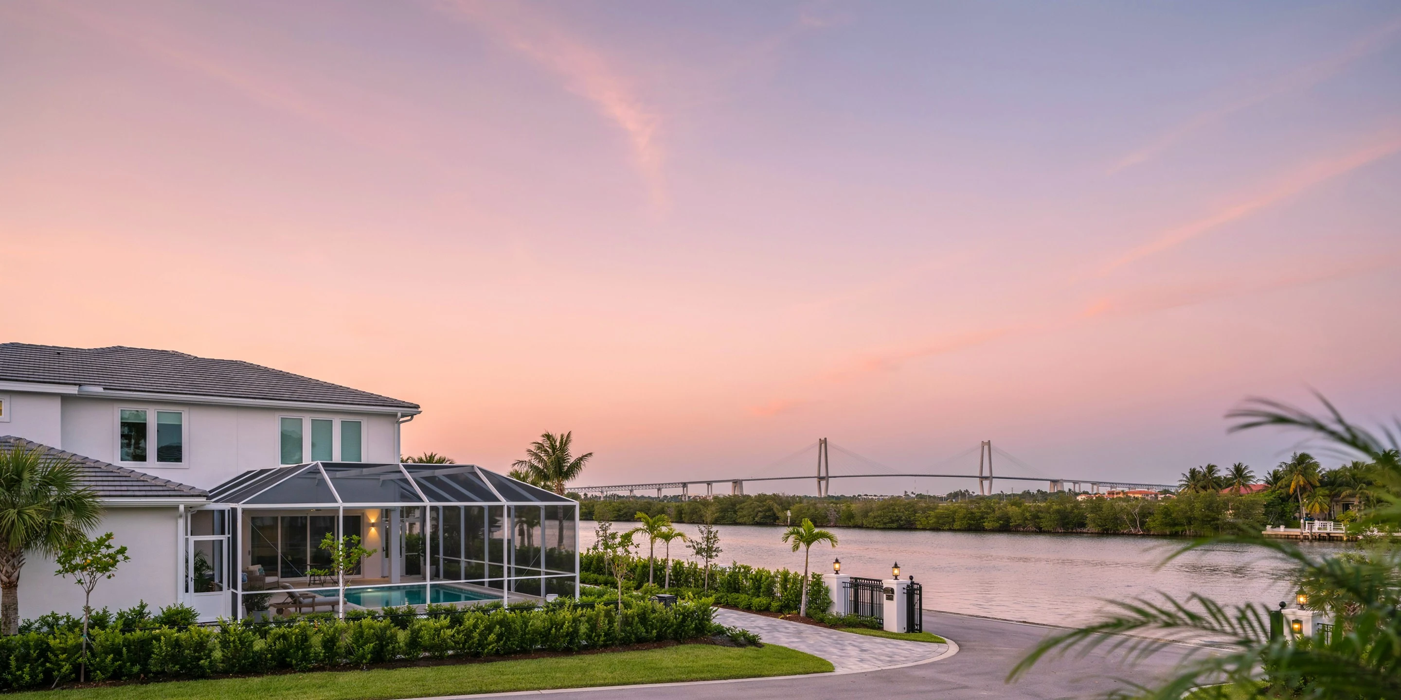 Pool cage home with the Skyway bridge on the horizon at sunset, Palmetto, FL